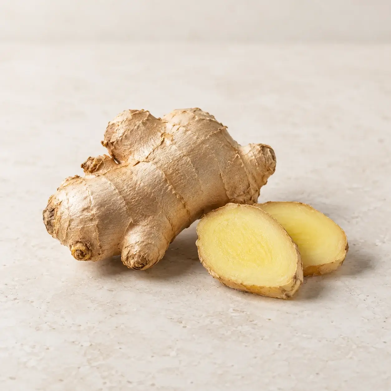 Fresh ginger root and two cut slices